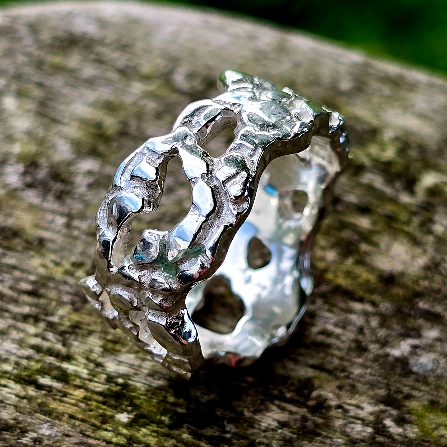 Offener, organisch geformter Silberring mit durchbrochener Struktur – handgefertigter Designring aus 925 Sterling Silber. Die Oberfläche ist unregelmäßig und erinnert an Korallen, Knochen oder verwittertes Gestein. Moderner Unikat-Ring für Individualistinnen, inspiriert von natürlichen Formen.